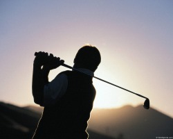 Golfer Swinging in sunlight